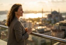 A person with a healthy, confident smile looking out over a sunlit, panoramic view of Istanbul, Turkey, representing a successful dental tourism trip from Canada.