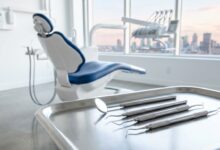 A photorealistic image of a modern, clean dental examination room. In the foreground, a tray of sterilized dental tools is in sharp focus. In the background, an empty dental chair and equipment are softly blurred, with a large window showing a faint, out-of-focus Canadian city skyline.