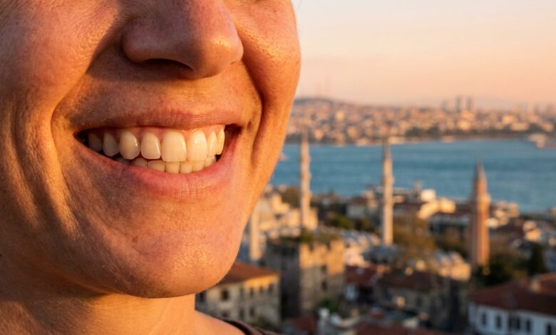 Close-up of a person's flawless, white smile, with a beautiful, sunlit, and blurred Turkish city coastline in the background, representing a successful dental tourism trip.