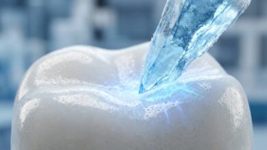 An abstract, photorealistic macro photo visualizing tooth sensitivity, showing a clean white enamel surface being touched by a piece of blue ice, creating a glowing blue reaction at the point of contact.