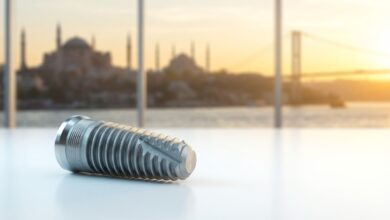 A photorealistic close-up of a modern titanium dental implant on a clean surface, with the beautifully blurred skyline of Istanbul, Turkey, visible through a window in the background during a warm sunrise.