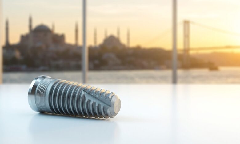 A photorealistic close-up of a modern titanium dental implant on a clean surface, with the beautifully blurred skyline of Istanbul, Turkey, visible through a window in the background during a warm sunrise.
