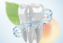 A pristine, healthy tooth glistening under bright, clean light. Around it, shimmering water gently flows, and subtle, glowing mineral particles are depicted, symbolizing natural strengthening and cleansing. The background is softly blurred with hints of green leaves or natural fruit, representing a holistic approach to oral health. There is no visible text.