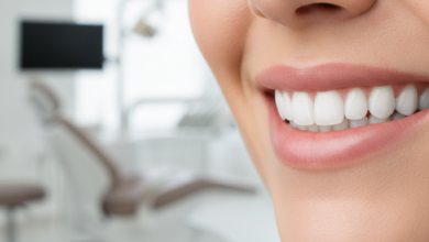 Close-up of a person with a bright, healthy, and confident smile, suggesting successful dental implant treatment. The background is a blurred, clean, and modern dental office interior.