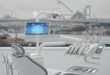 A modern, sterile dental chair and advanced dental equipment in sharp focus in the foreground, with a blurred backdrop of an iconic Turkish cityscape featuring domes, minarets, and a bridge over water, representing international dental tourism.