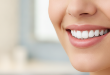 Close-up of a person with a radiant, perfect white smile and healthy, bright teeth, against a soft, blurred, clean, and modern background.
